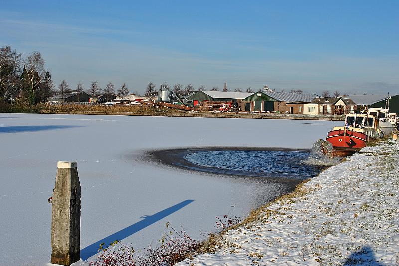 27-SpillingIce.jpg - Water pumped into the canal, from a cleaning mill, keeps the watr open