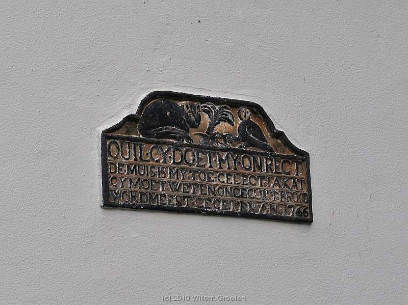 09-Stone.jpg - A stone in the white wall of the extension tells the conversation between an owl and a cat, over a mouse.